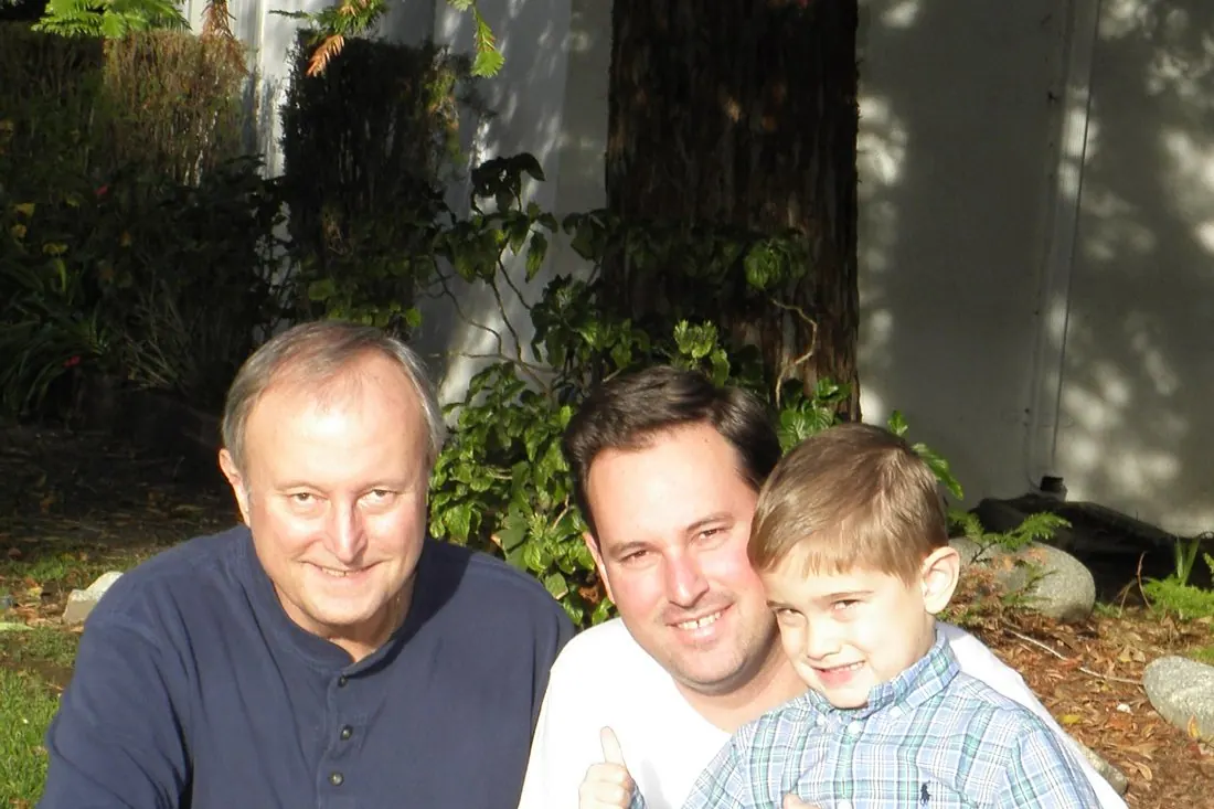 Three generations of Bollinger men kneeling together.